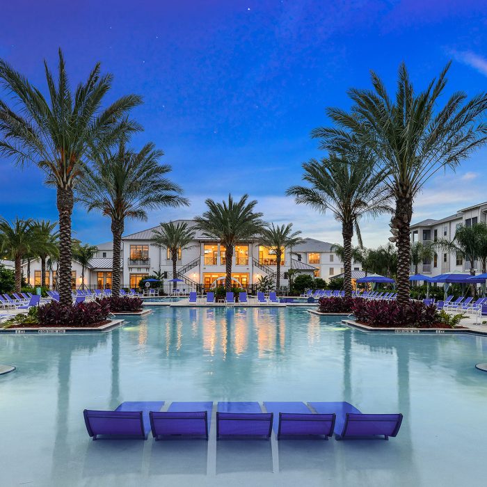 Resort facility with lounge chairs and palm trees