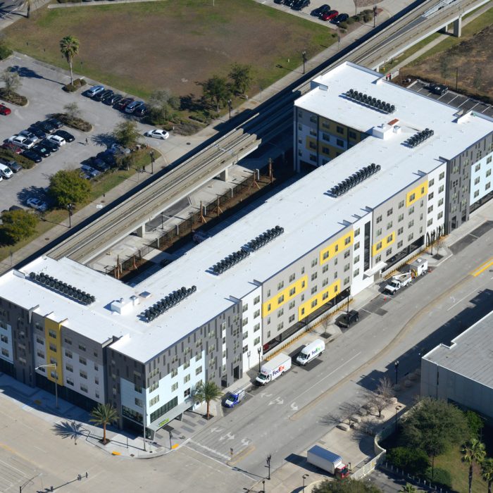 Multi story apartment complex aerial view with parking lot