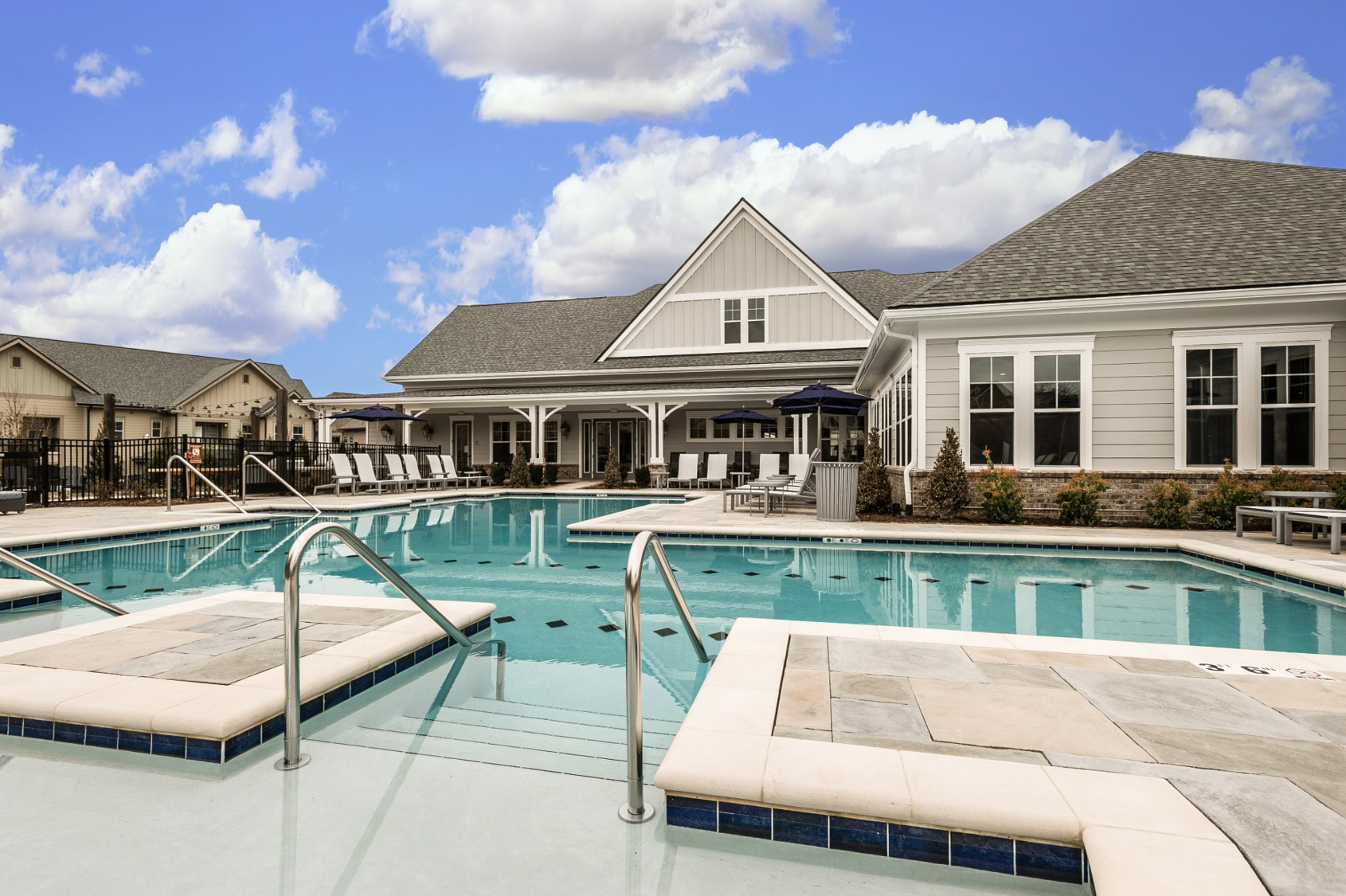 High end apartment complex pool area with pool house
