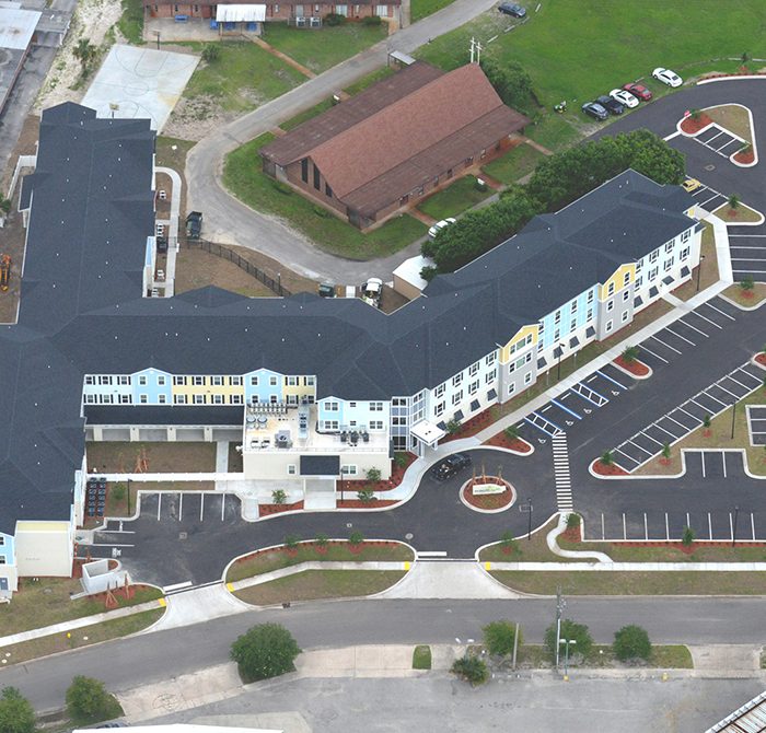 Multi story mixed use apartments by church aerial view