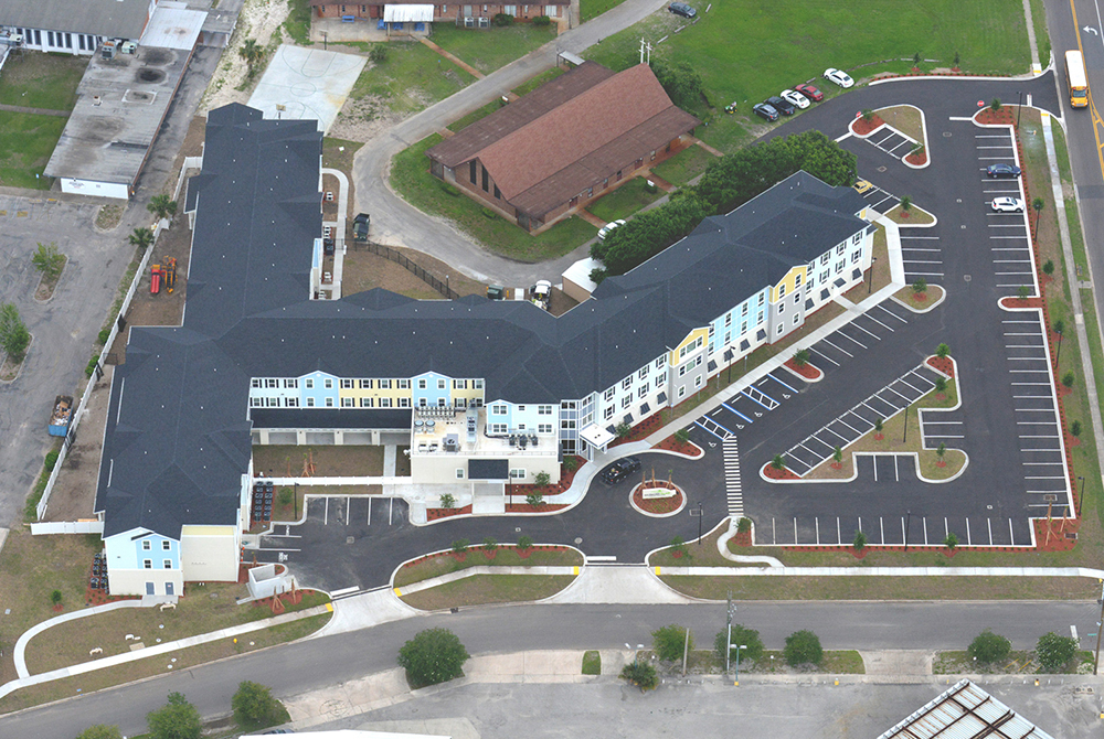 Multi story mixed use apartments by church aerial view