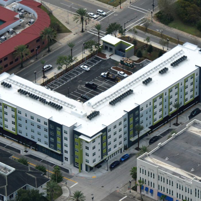 Multi story green and white apartments aerial view