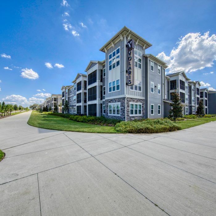Multi story apartment building with Volaris sign