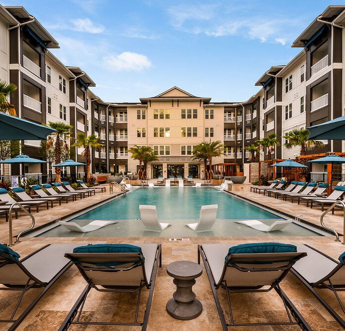 Luxury multi story apartments pool area with lounge chairs
