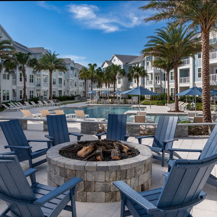 Luxury multi story apartment complex view with fire pit