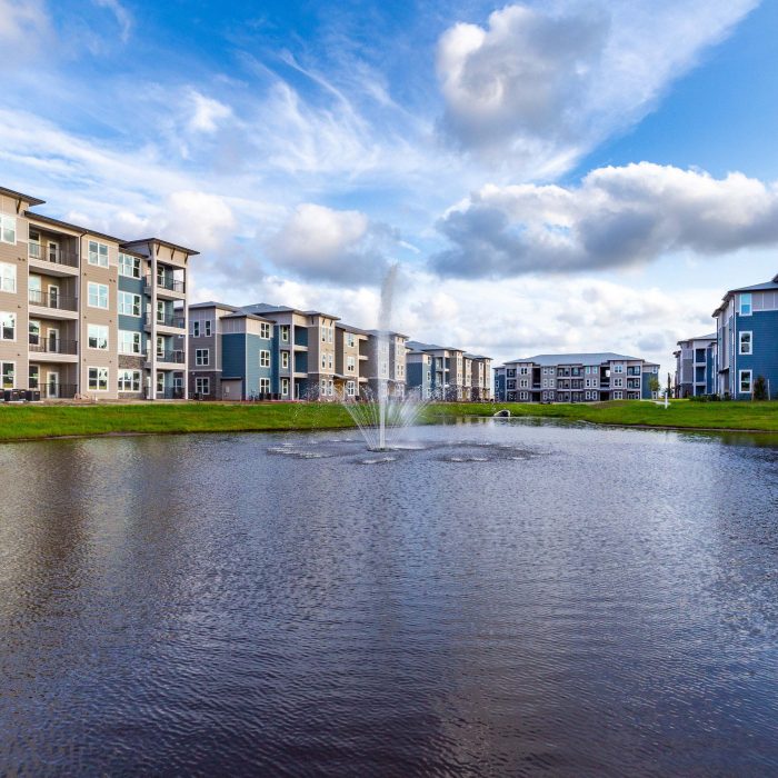Multi story apartment building by pond