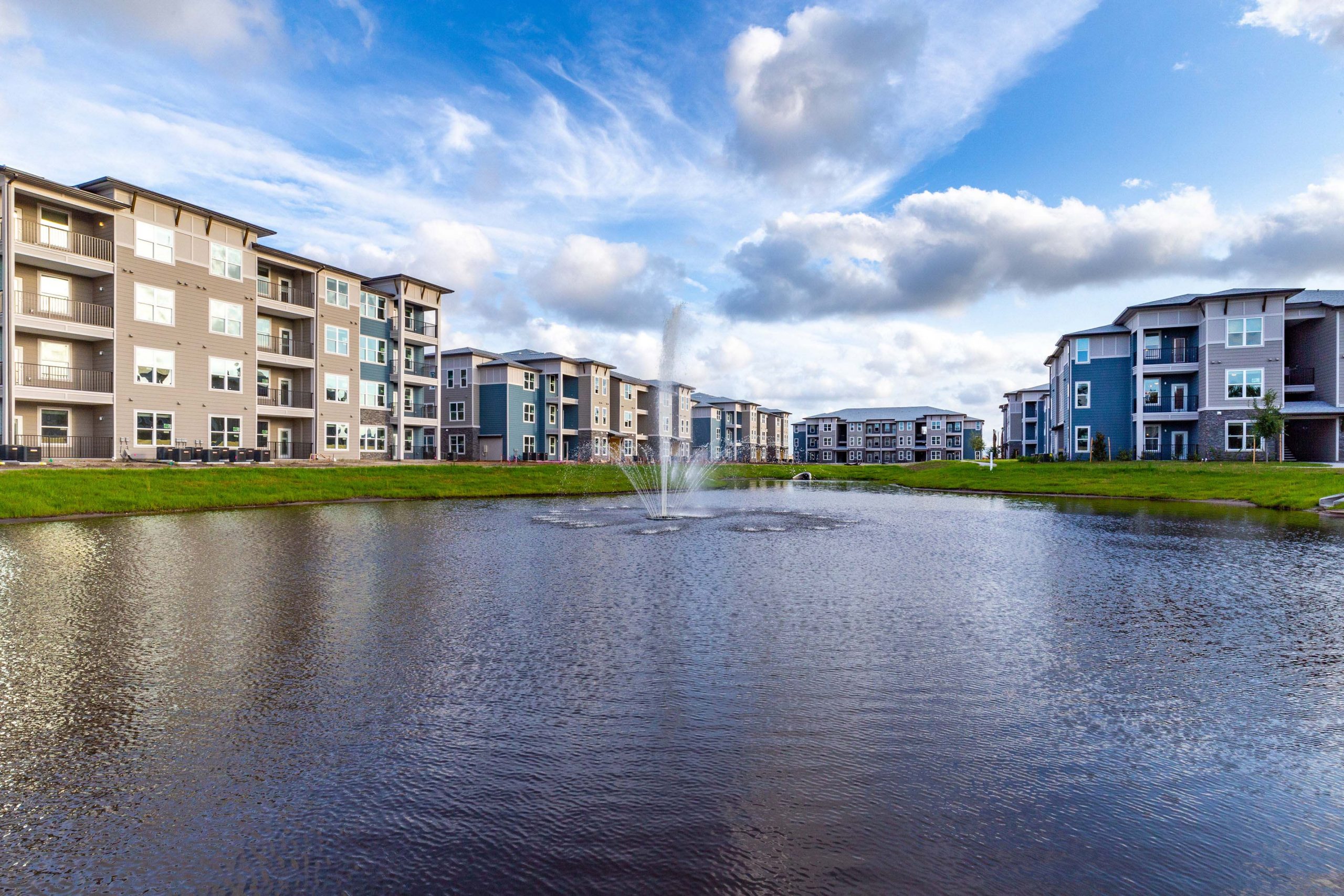 Multi story apartment building by pond