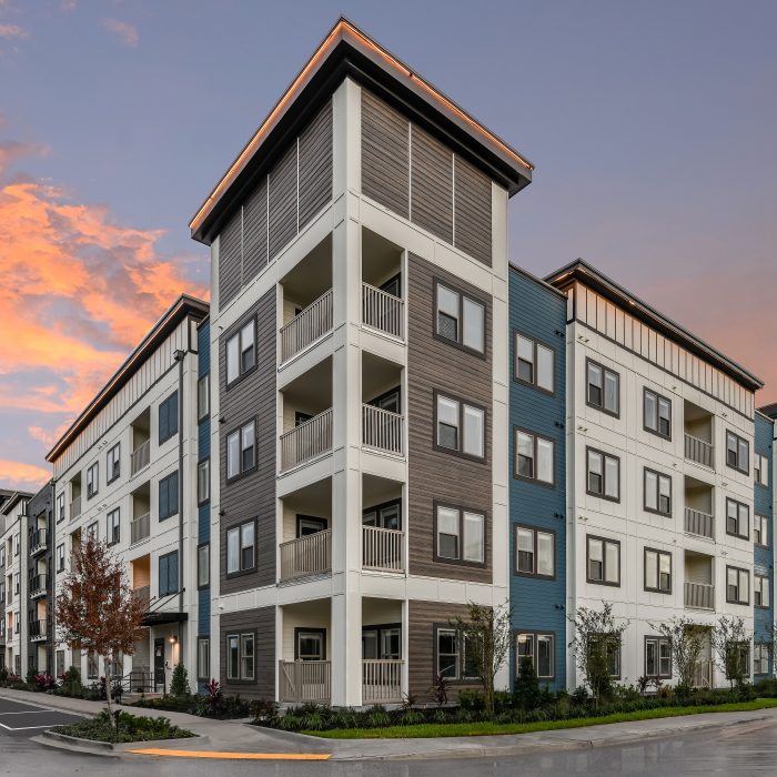 Multi story apartment building corner entrance in evening