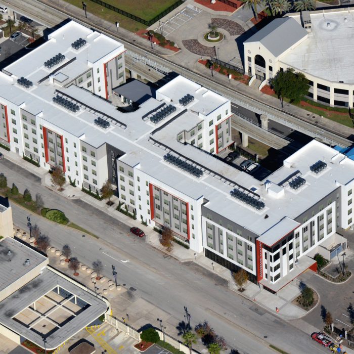 Red white and gray multi story apartment building aerial view