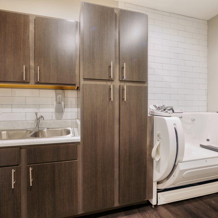 Personal room for seniors with wood cabinets and a handicap accessible bath