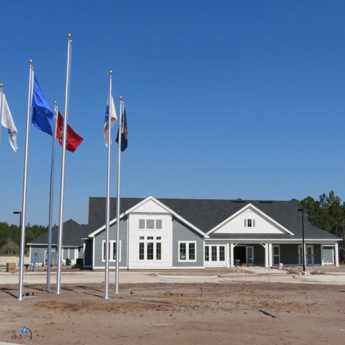 K9s For Warriors Project by Summit Contracting Group building with flagpoles