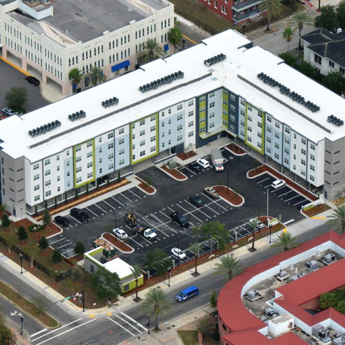 Multi story apartment complex with parking lot aerial view