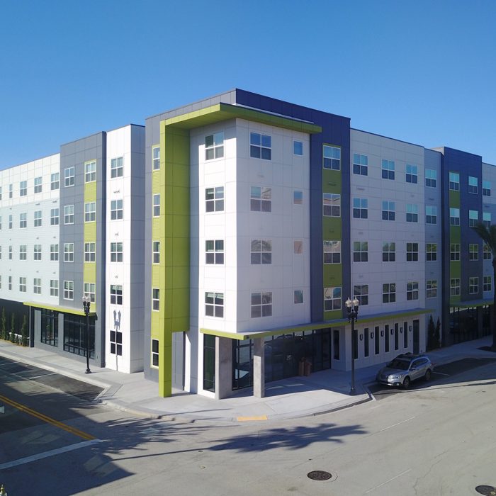 Multi story apartment complex entrance by sidewalk