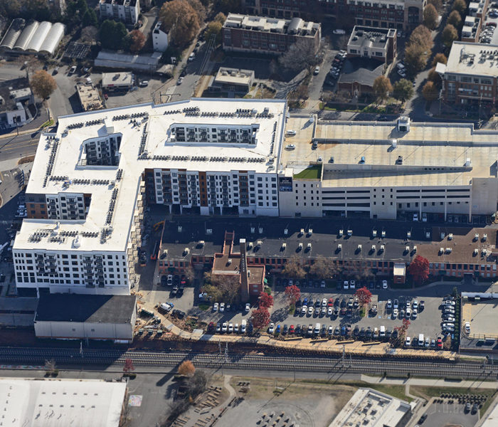 aerial view of Novel Atherton Mill stack, large building and parking garage