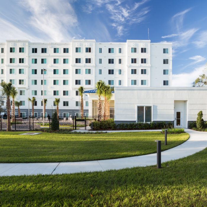 Madison Crossing Market Rate Senior Living Apartments walking path behind building