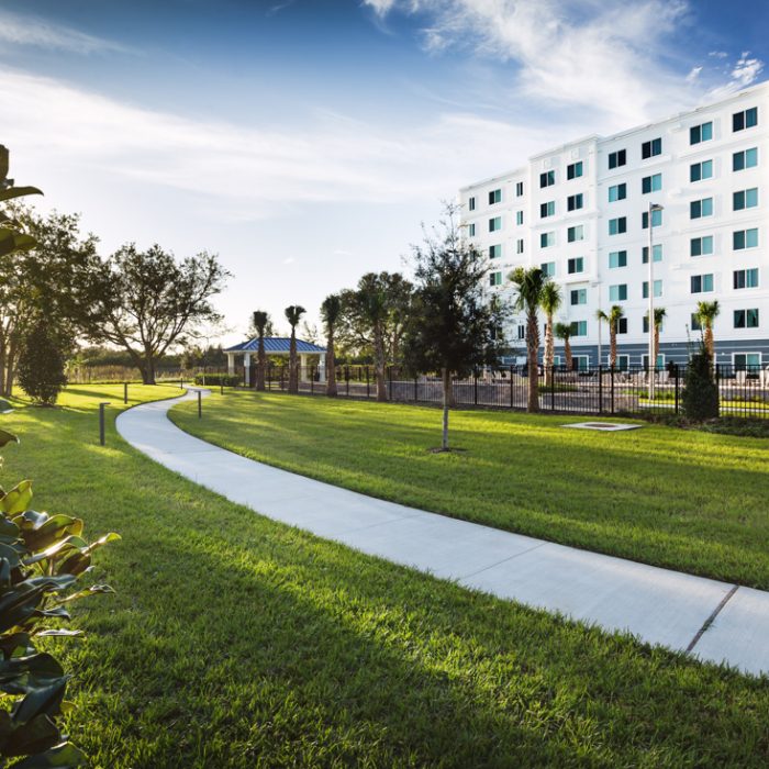 Madison Crossing Market Rate Senior Living Apartments walking path behind building