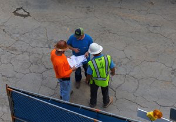 Group of construction workers planning at Summit Construction Group site