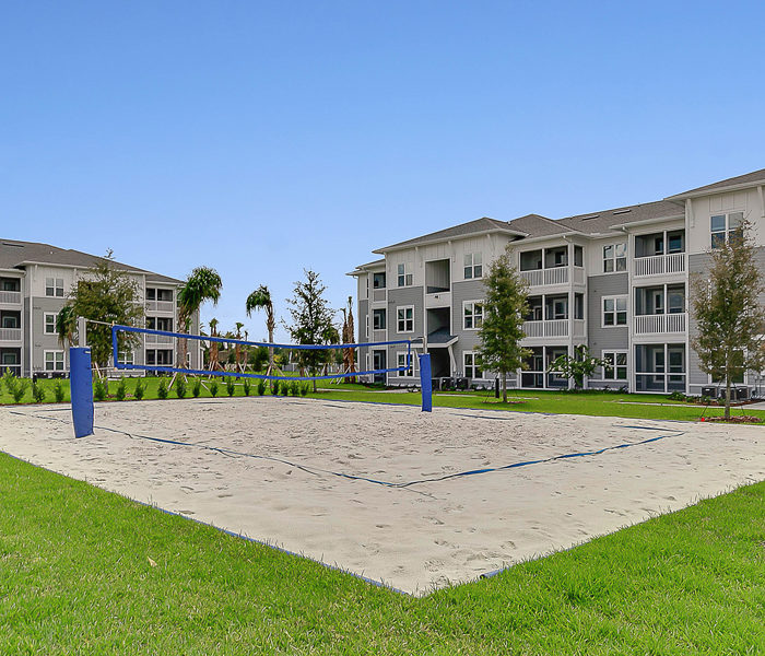 cropped image of beach volleyball and apartments buildings