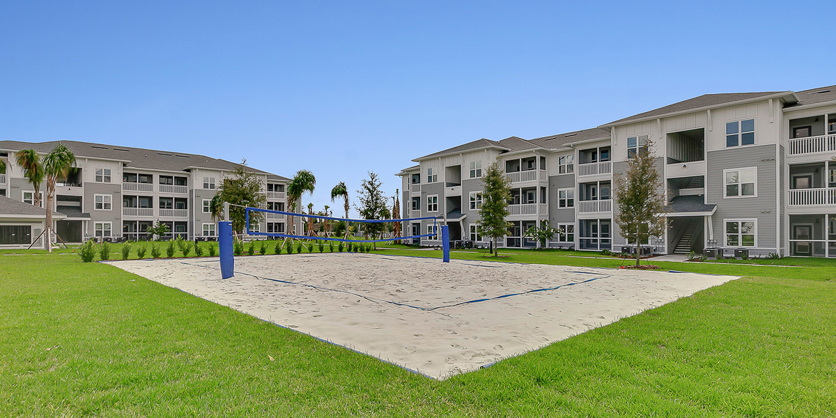 cropped image of beach volleyball and apartments buildings