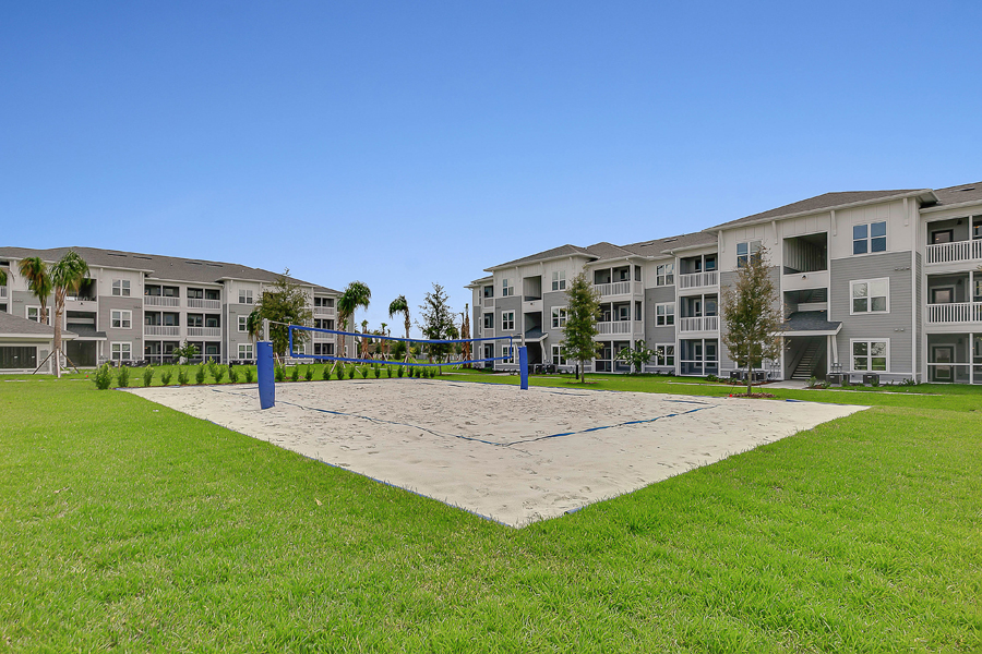 Beach volleyball and apartments buildings at Sentosa Beachwalk