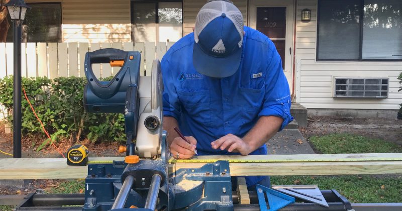 Summit employing wood working in front of home