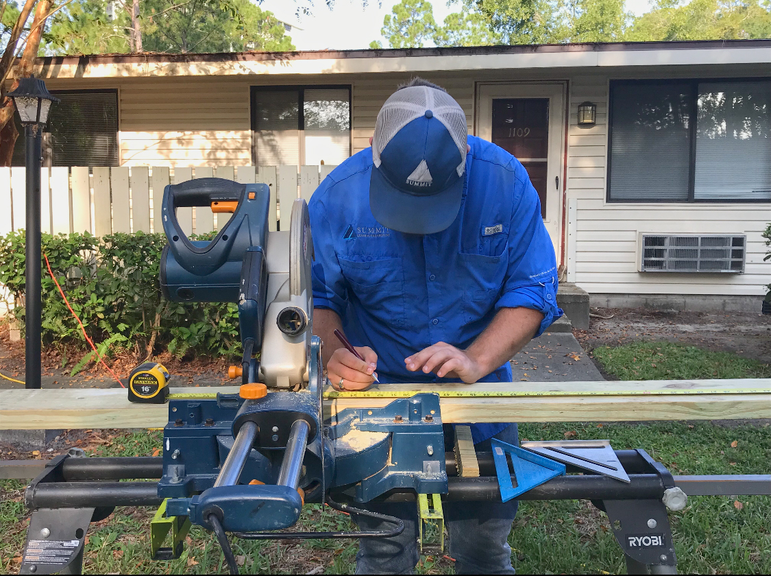 Summit employing wood working in front of home