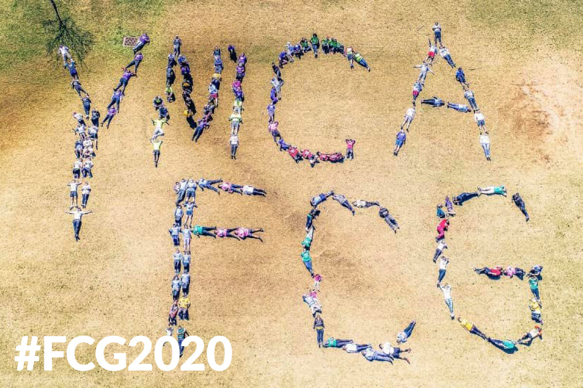 Aerial view of "YMCA FCG" spelled by people doing yoga for #FCG2020