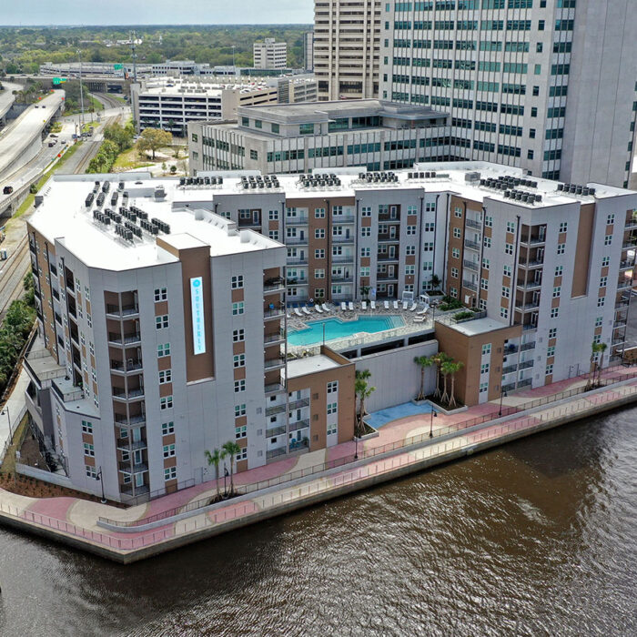 8 story apartment building next to a river
