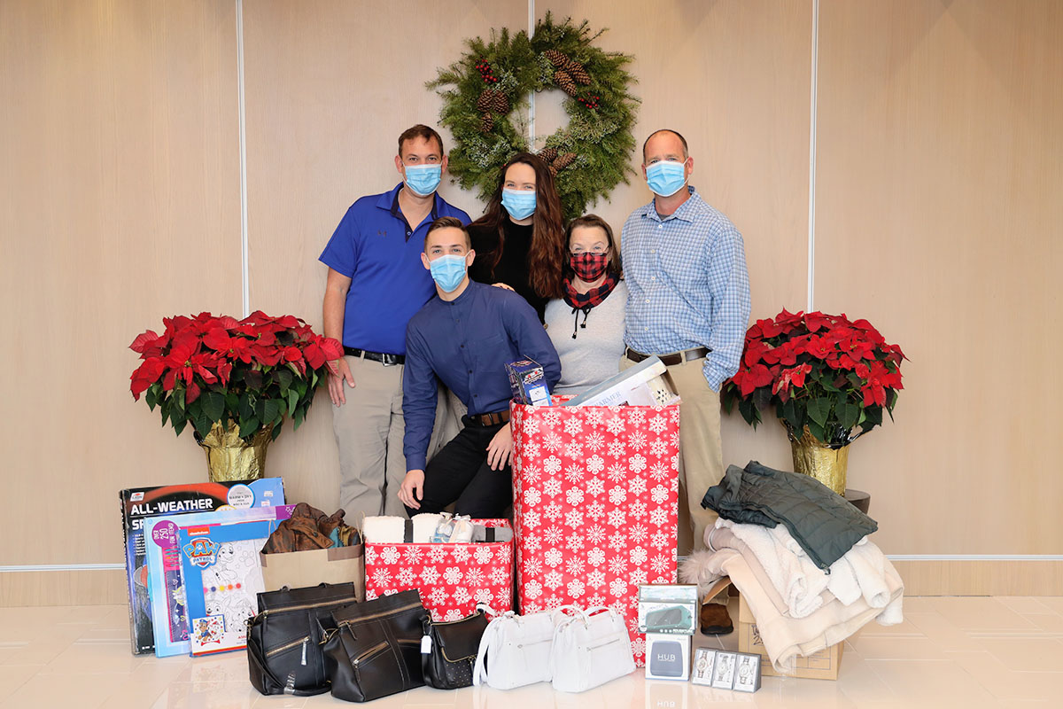 group of people with holiday donations