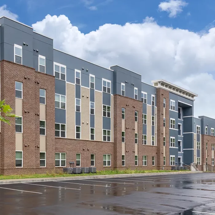 4 story apartment building with brick facade