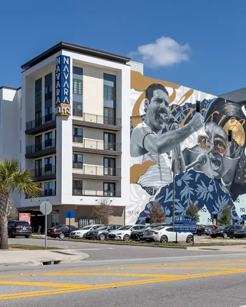 view of 6 story apartment building with mural depicting musicians