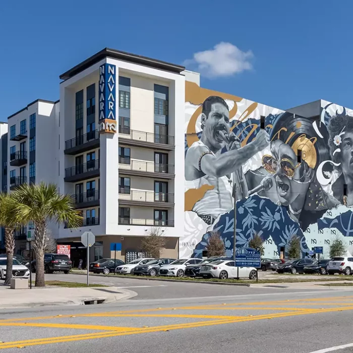 view of 6 story apartment building with mural depicting musicians