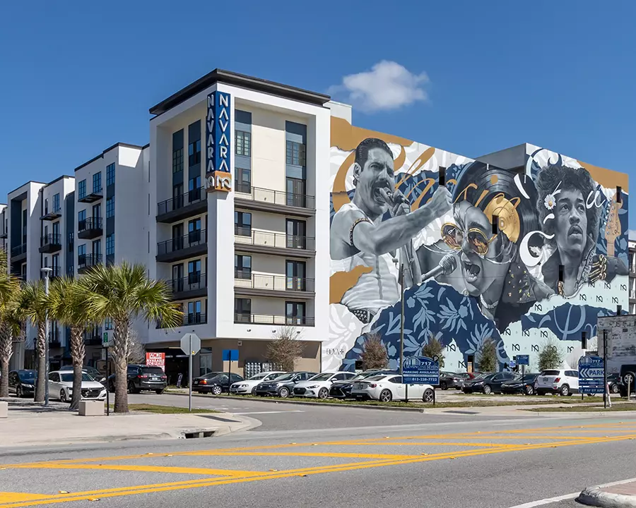 view of 6 story apartment building with mural depicting musicians