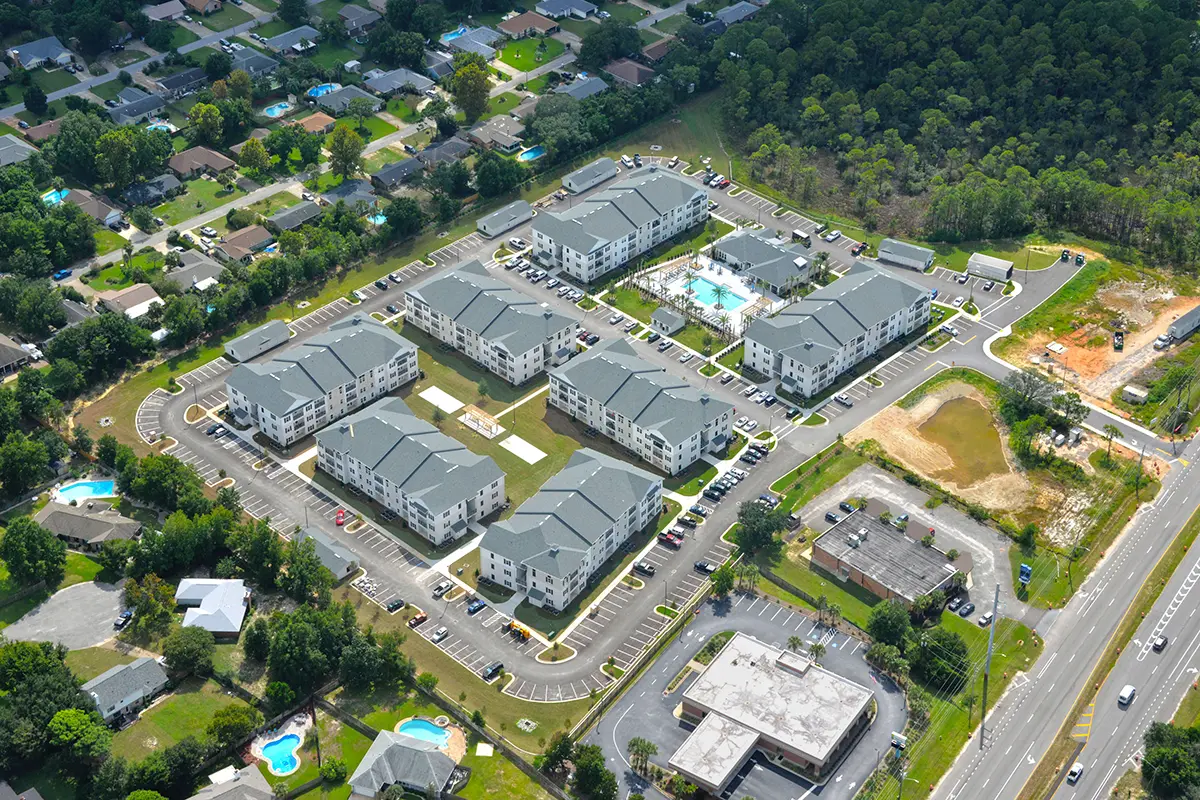 aerial view of apartment complex with 8 buildings and a swiming pool