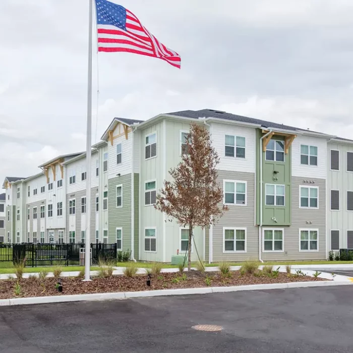 3 story apartment building with US flag