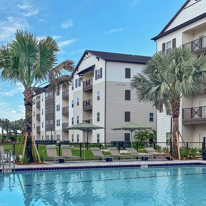 4 story apartment building next to swimming pool