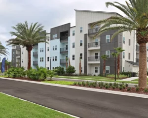 4 story apartment building with palm trees