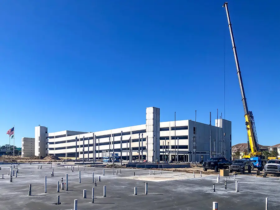 concrete parking garage under construction with crane