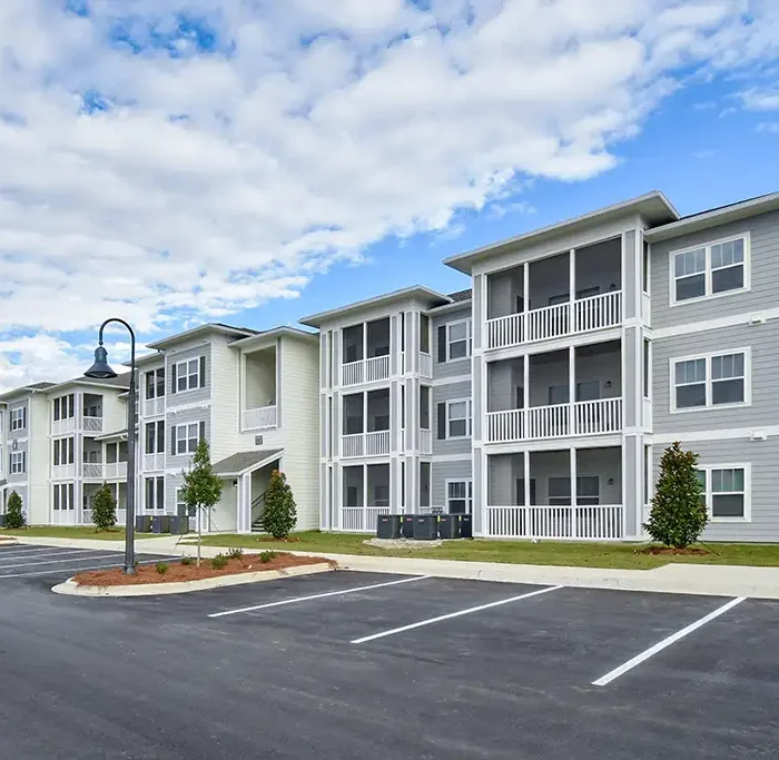 3 story apartment building with screened in balconies and porches