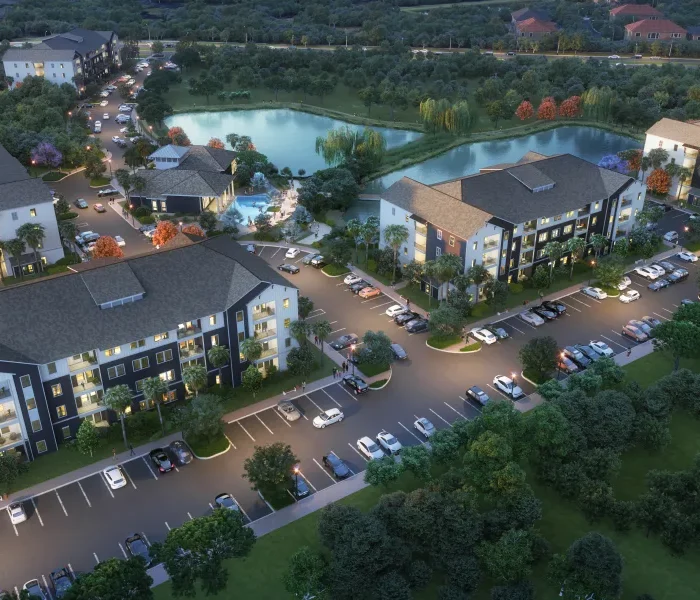 architect's rendering of an aerial view of an apartment development with 4-story buildings and a 1-story clubhouse with swimming pool