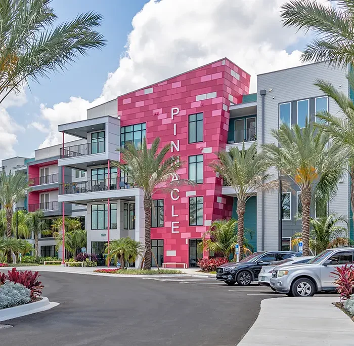 front entrance of modern 4 story apartment building