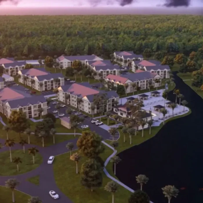 architects rendering of an apartment community from an aerial view at dusk