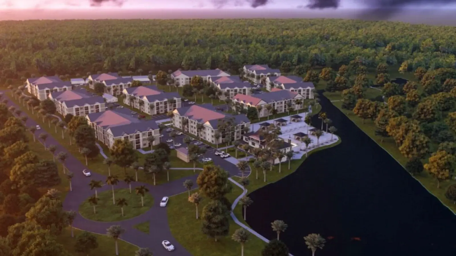 architects rendering of an apartment community from an aerial view at dusk